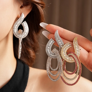 Detail showing oversized multi-layer hoop earrings with shimmering rhinestones on model