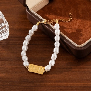 Elegant baroque pearl bracelet with 11:11 engraved gold tag and stainless steel clasp