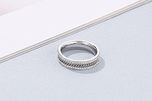 Macro shot of titanium steel ring with double-row cubic zirconia and chain link texture