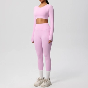 Close-up of pink long-sleeve crop top and high-waist leggings with side pockets