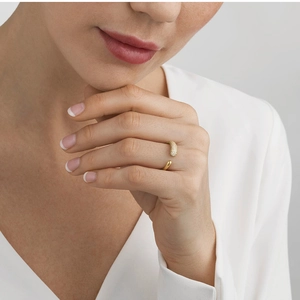 Detail of gold-plated titanium ring featuring irregular pavé cubic zirconia and adjustable band