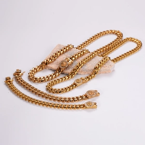 Golden stainless steel Cuban link necklace and bracelet set with lion head pendant