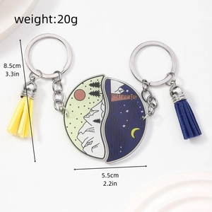 Detailed size view of acrylic sun and moon puzzle keychain set with tassel charms