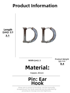 Detailed view of silver D-letter earrings with zircons and precise measurements