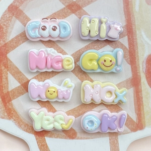 Detailed view of colorful 3D resin letters and cute word charms on an orange checkered plate