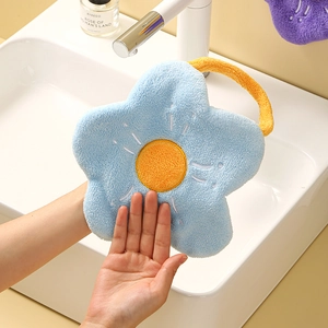 Detail of flower shaped coral fleece hand towel in blue and yellow with hanging loop