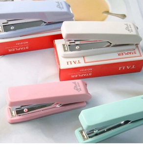 Close-up of pastel staplers in macaron colors including light blue and mint green