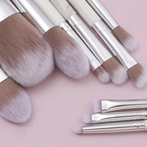 Professional 10-piece marble texture makeup brush set on a soft pink background