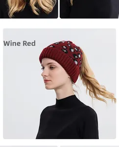Detail view of burgundy leopard print knit beanie with convenient ponytail hole opening
