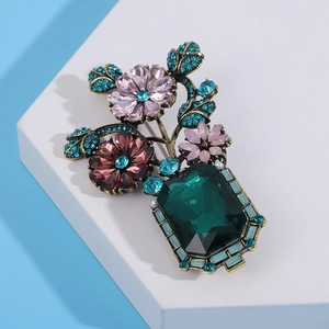 Detail of vintage Baroque brooch with crystal-inlaid flowers and enamel finish
