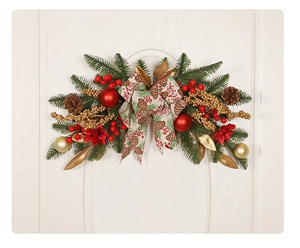 Detail view of a lush Christmas wreath with pine cones and red berries on a white door