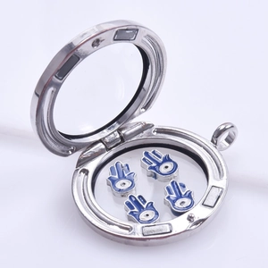 Macro shot of silver glass locket featuring blue Hamsa hand charms for DIY bracelets