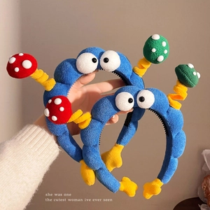 Cute blue plush headband with big cartoon eyes and colorful mushroom antennas