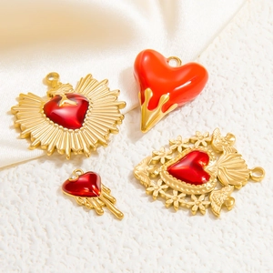 Macro view of 18k gold plated heart pendants with red enamel and zircon details