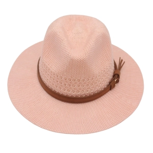 Detail of the pink woven straw fedora hat with brown leather band and tassel accents