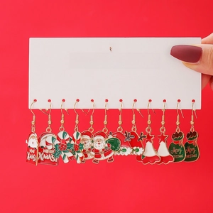 Detailed view of 6-pair Christmas themed earrings with enamel Santa and tree designs