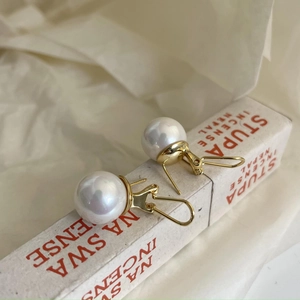 Elegant 925 sterling silver leverback earrings with large round white pearls on fabric