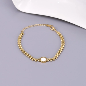 Detail of 18K gold plated bracelet with leaf-shaped links and white mother of pearl