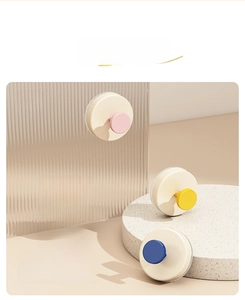 Detailed close-up of vibrant suction cup wall hooks in pink, red, yellow, and blue colors
