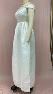 Close-up of elegant white satin off-the-shoulder dress with high-slit and flared hem