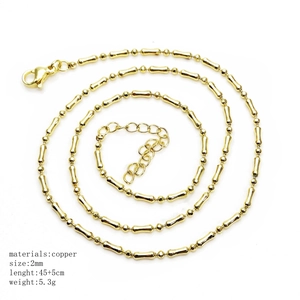Detail of 2mm golden bamboo link chain with lobster clasp and adjustable tail chain