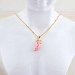 Detail of gold necklace with pink horn pendant and colorful crystals on model neck