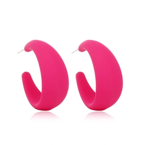 Detailed side view of oversized matte pink hoop earrings with a professional studio finish