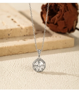 Macro view of vintage octagonal silver necklace with large faceted crystal pendant