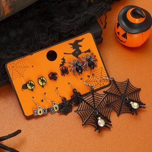 Halloween earring set with black spider, web and BOO charms on festive orange background