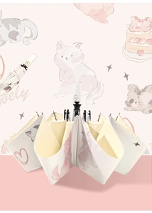 Detail of compact cream-colored umbrella featuring cute pink cartoon cat illustrations