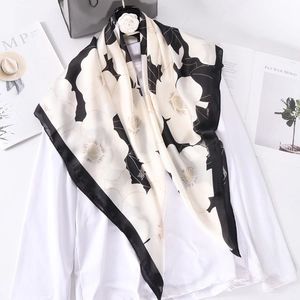 Elegant 90x90cm black and white floral satin square scarf draped over a white blouse