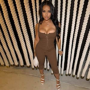Close-up detail of the brown ribbed knit bodysuit featuring a stylish lace-up front design