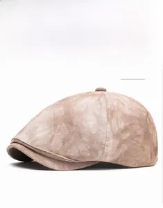 Detail view of khaki newsboy cap showing textured fabric and structured multi-panel crown