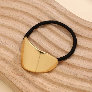 Detail of high-elastic black hair tie with polished gold geometric metal ornament