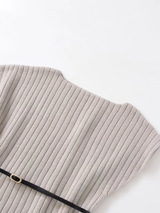 Detail of grey ribbed knit top featuring a slim black belt with golden metal buckle
