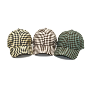 Three hounds-tooth knit baseball caps in yellow, brown, and green for autumn outdoor wear