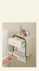 Detail view of wall-mounted tissue box featuring partition storage and cream white finish