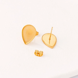 Golden teardrop stainless steel stud earrings with butterfly backs on white background