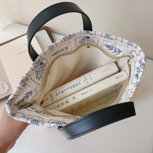 Detail view of large interior space in floral canvas tote bag with metal zipper