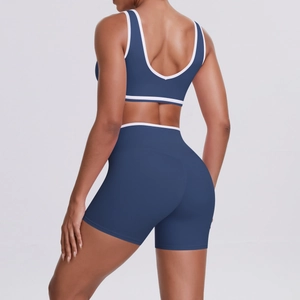 Deep blue yoga set with sports bra and high-waist shorts featuring white contrast trim
