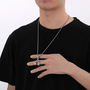 Retro vintage boxing glove necklace in silver stainless steel worn by a male model