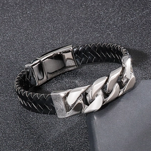 Detail of black braided leather combined with polished silver stainless steel Cuban chain
