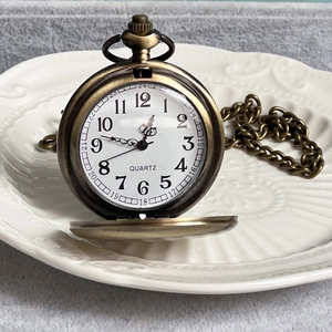 Macro shot of bronze vintage pocket watch dial with Arabic numerals and quartz movement