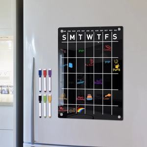 Macro view of magnetic black acrylic weekly calendar with 6 markers on a steel fridge