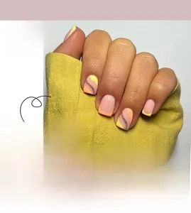 Detail of short French press-on nails with yellow and peach glitter wavy line patterns