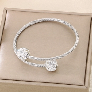 Detail of silver twisted wire steel bangle featuring sparkling rhinestone-inlaid spheres