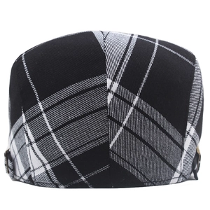 Detail of black and white checkered flat cap with adjustable side metal buckle