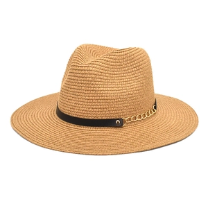 Close-up of woven straw hat featuring a black leather band and gold chain detail