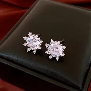 French style silver snowflake stud earrings with sparkling zircon on a black leather box