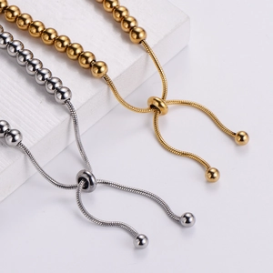Adjustable stainless steel bead bracelet in gold and silver with sliding buckle